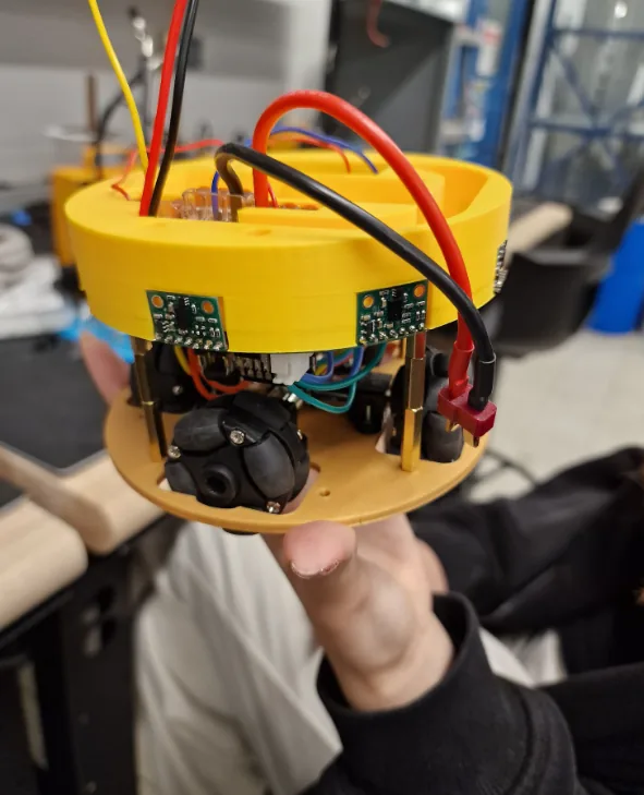 The compact 2026 PacBot robot with its electronics and sensors visible